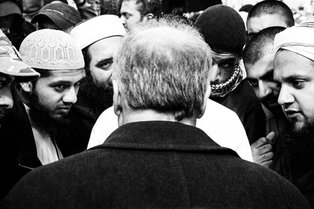 George Galloway, the then Member of Parliament (MP) for Bradford West, discusses the ongoing conflict in Iraq with a group of anti-war demonstrators in Trafalgar Square, London, UK. Image copyright © Thaddeus Pope, 2004.