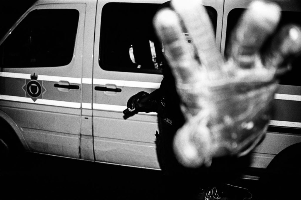 A British policeman during an anti-war protest against the invasion of Iraq in Brighton, England (2003). Image © Thaddeus Pope