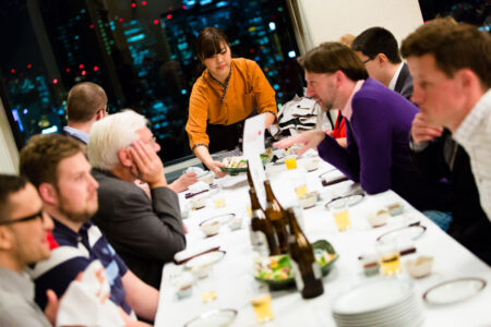 Conference delegates get to know each other at the conference dinner, which offers attendees the chance to sample local cuisine. Here they are served traditional Japanese food and sake as they look over the impressive Osaka skyline. Conference delegates get to know each other at the conference dinner, which offers attendees the chance to sample local cuisine. Here they are served traditional Japanese food and sake as they look over the impressive Osaka skyline.