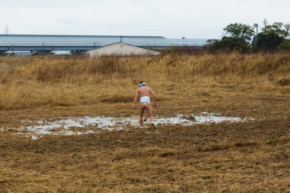 Wearing nothing but a fundoshi (a traditional Japanese undergarment), a festival organiser checks to see whether it is suitably waterlogged enough for the Nakata Hadaka Matsuri (Naked Festival) to take place.