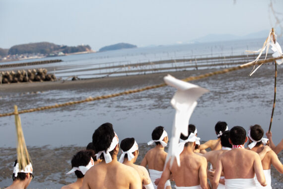 After prayers and offerings have been made by the shinto priests, the men march across the sand towards the sea for the ritual purification known as misogi.