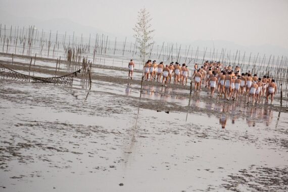The men walk into the sea for the ritual purification of misogi.