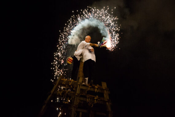 Two men prepare to light an enormous Tezutsu Hanabi mounted on a shrine-like frame at the close of the annual Toyohashi Gion Matsuri in Aichi Prefecture, Japan. Two men prepare to light an enormous Tezutsu Hanabi mounted on a shrine-like frame at the close of the annual Toyohashi Gion Matsuri in Aichi Prefecture, Japan.