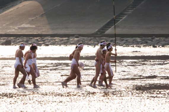 The two shin-otoko lead the men back to the beach after completing the ritual purification of misogi.
