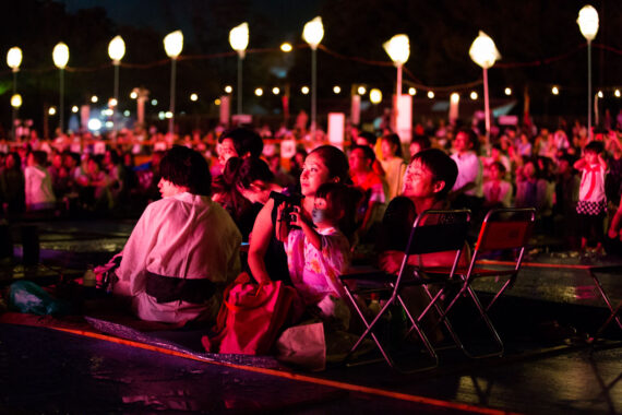 Young Japanese girl photographs the Toyokawa tezutzu Festival in Aichi Prefecture, Japan (2014).