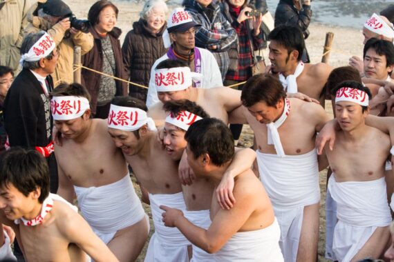 Spectators greet the men as they return to the beach.