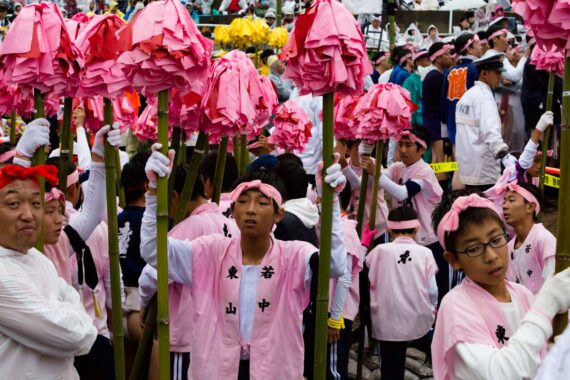 Boys from Higashiyama district holding "shide" (bamboo poles decorated with colourful paper) at the Nada no Kenka Matsuri, also known as the Nada Fighting Festival, in Shirahama Town in Hyogo Prefecture, Japan.
