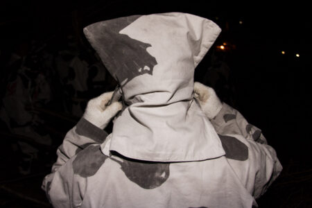 The costumes worn by Toba-dai-kagaribi festival participants are made from the thick cotton banners of previous festivals. Because of the catlike appearance of their hoods, the men are often referred to as ‘neko’ (cats) by local townspeople. From the series "The Great Bonfire of Toba".