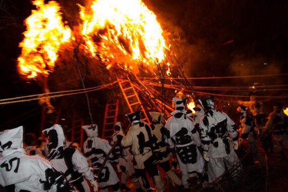 With prayer rites finished and offerings for a good harvest made, torches are used to light the giant towers while the two teams wait in anticipation.