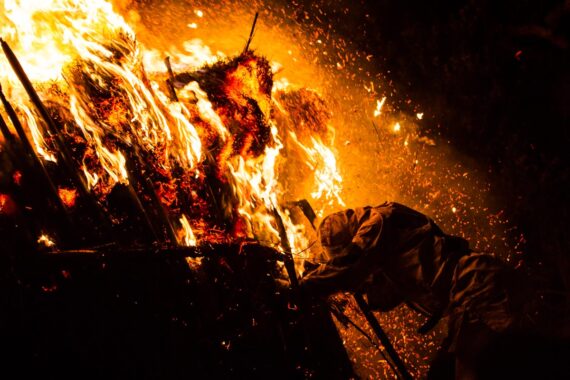 Though visibly exhausted by the task at hand, the men continue to shake and tear at the towers.