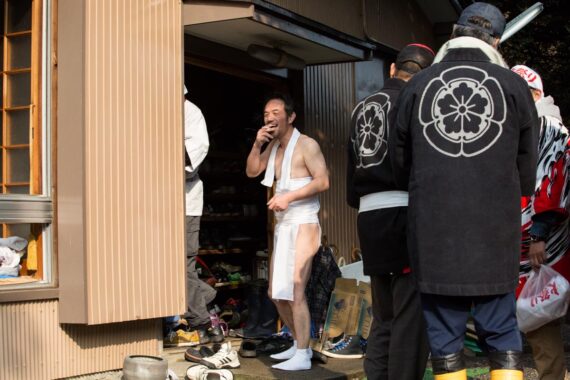 Shoes pile up in the entranceway to Toba Shinmeisha Shrine as the men change into festival clothes and traditional split toe boots (jika-tabi).