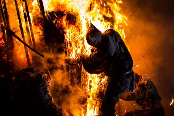 In an impressive display of courage and teamwork, the men tear at the towering inferno, forcing it apart and weakening its structure. From the series "The Great Bonfire of Toba".
