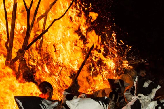 With the structure of the suzumi compromised, the men are able to use their combined weight and strength to pull it over.