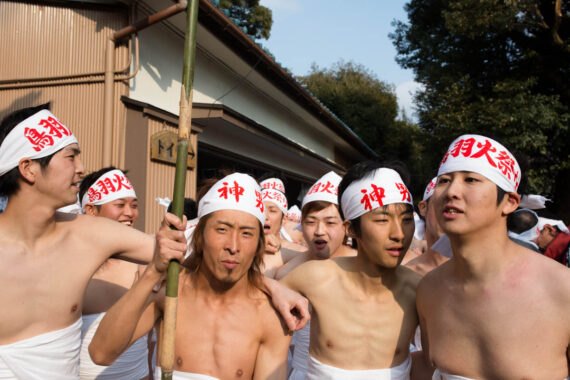 Festival participants lineup behind the two shin-otoko (pictured centre left and right) who will lead them to the sea for the ritual purification of misogi.