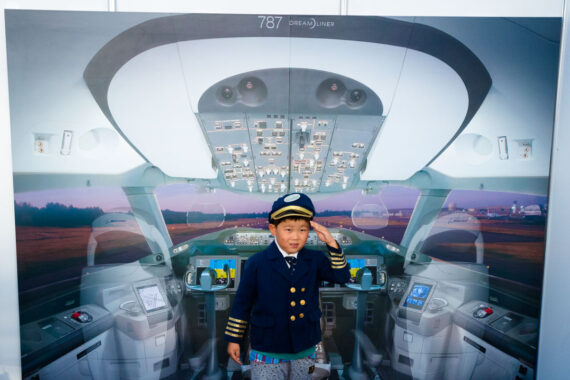 A young boy poses for a photograph at the Chubu Centrair International Airport booth in Oasis 21 in Nagoya, Aichi Prefecture, Japan.