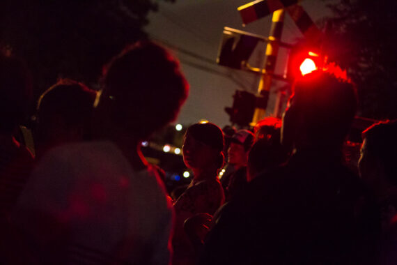 Spectators make their way to the Toyokawa Tezutsu Matsuri (Hand-Held Fireworks Festival), Toyokawa, Aichi Prefecture, Japan.