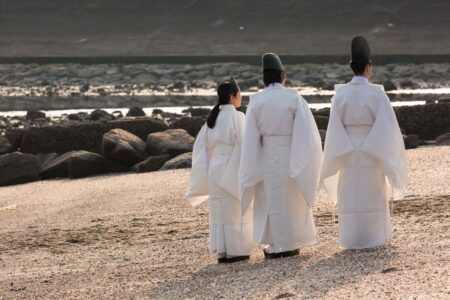 Shinto priests wait for the men to arrive at the beach.