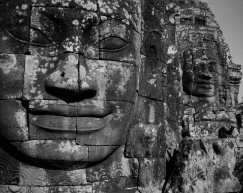 Prasat Bayon, Angkor Thom, Cambodia, 2009.
Built in the late 12th or early 13th century as the official state temple of the Mahayana Buddhist King Jayavarman VII, the Bayon stands at the centre of Jayavarman's capital, Angkor Thom. Following Jayavarman's death, it was modified and augmented by later Hindu and Theravada Buddhist kings in accordance with their own religious preferences. The smiling stone faces at Prasat Bayon in the Angkor Archaeological Park