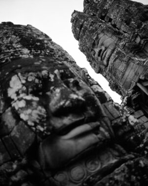 Prasat Bayon, Angkor Thom, Cambodia, 2009.
Built in the late 12th or early 13th century as the official state temple of the Mahayana Buddhist King Jayavarman VII, the Bayon stands at the centre of Jayavarman's capital, Angkor Thom. Following Jayavarman's death, it was modified and augmented by later Hindu and Theravada Buddhist kings in accordance with their own religious preferences. The smiling stone faces at Prasat Bayon in the Angkor Archaeological Park